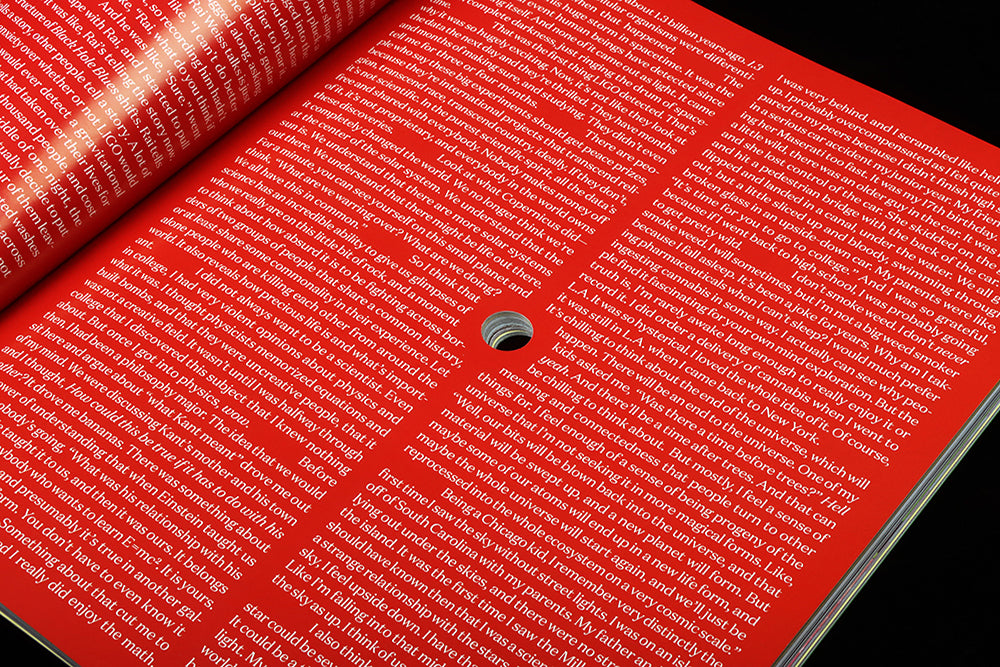 Red page with white text, and a hol drilled in its centre